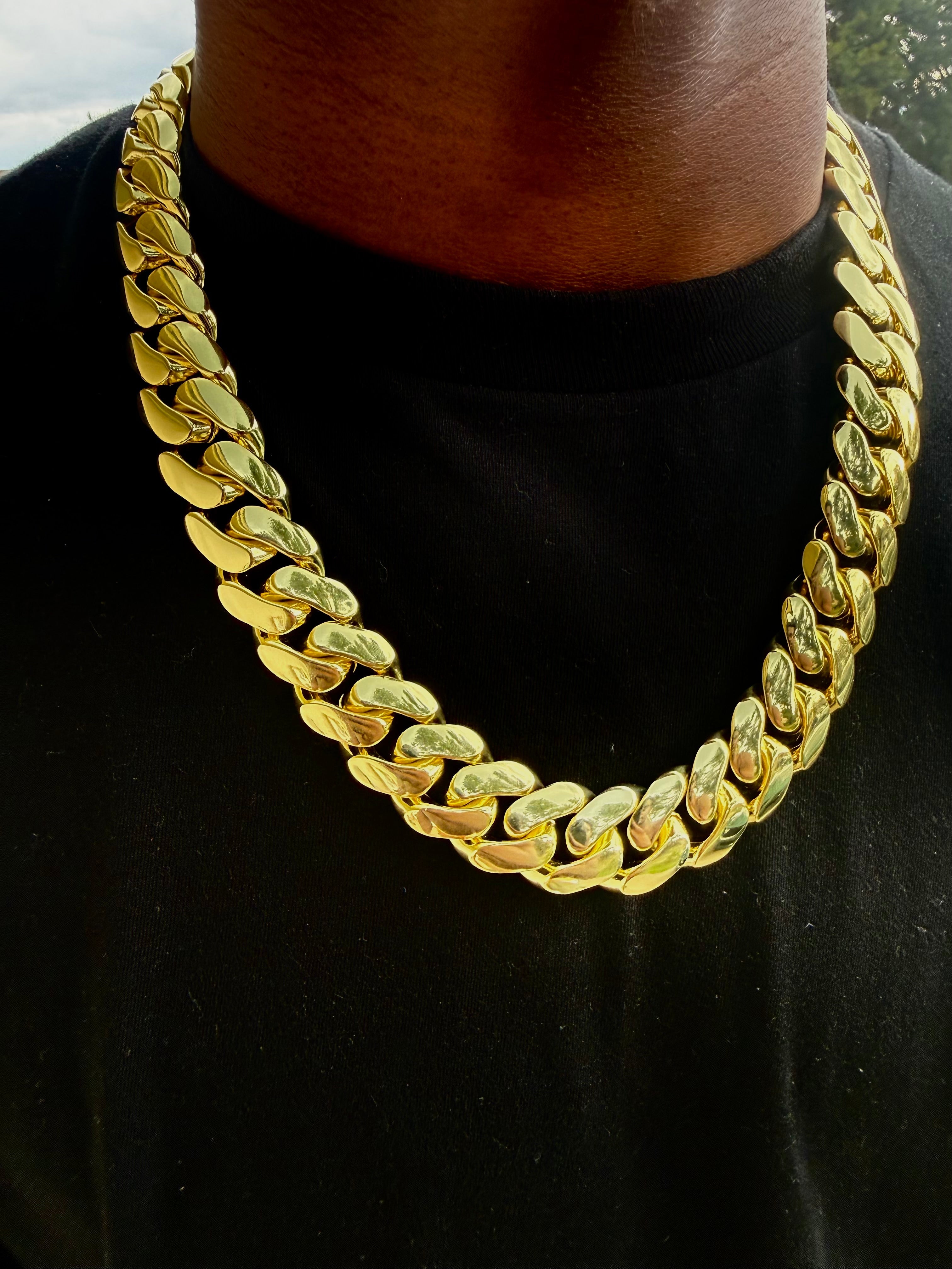 Yellow gold Cuban link chain laid flat showing full length