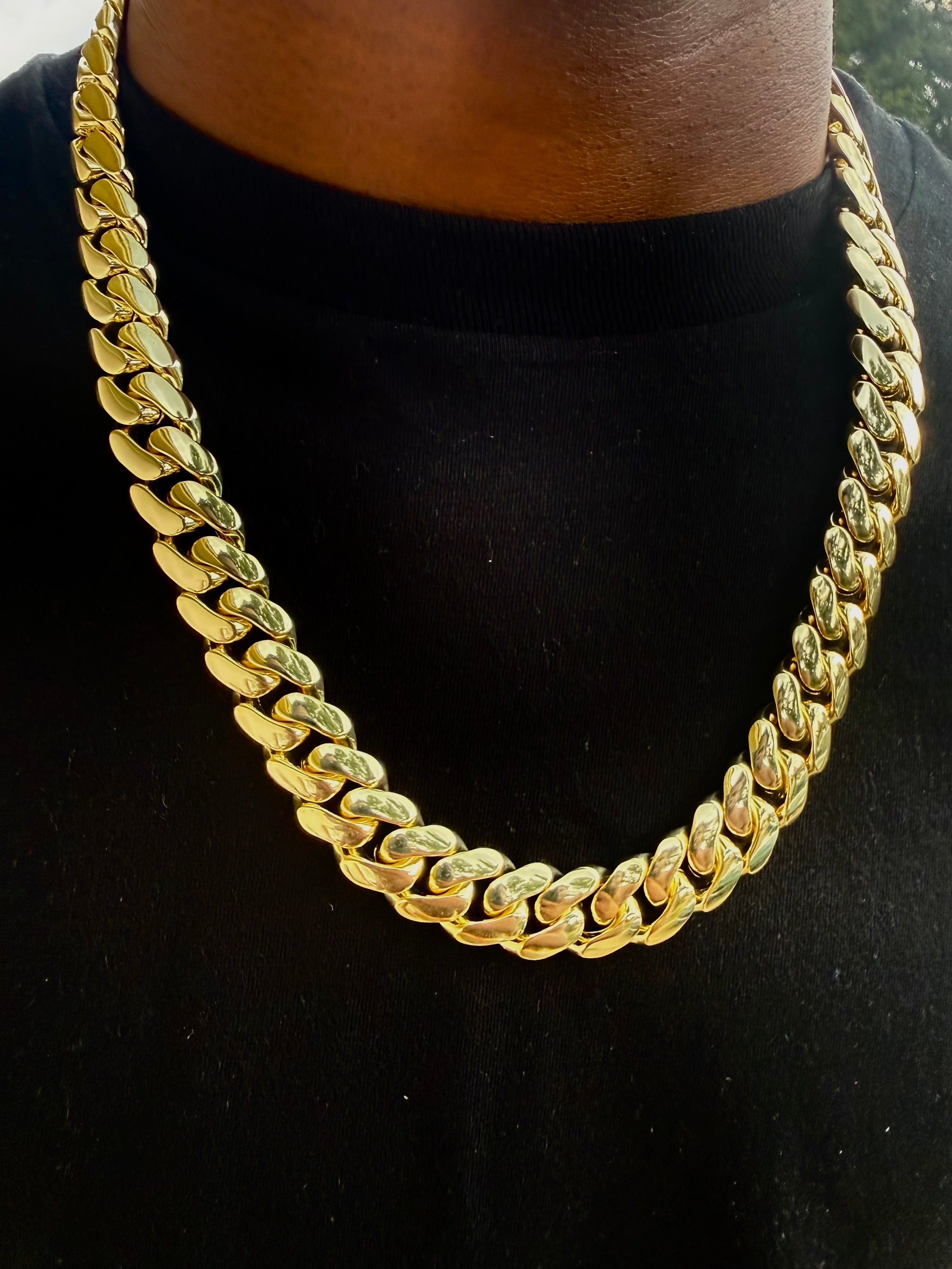 Yellow gold Cuban link chain worn on model, unisex jewelry